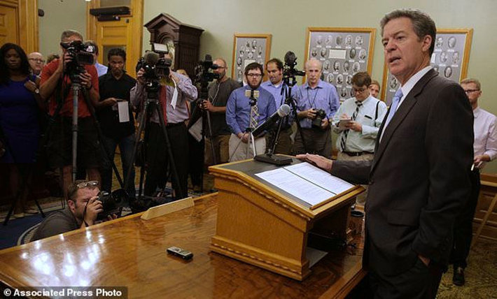 Kansas Gov. Sam Brownback talks to reporters Thursday, July 27, in Topeka, Kansas., after being nominated to be Ambassador-at-Large for International Religious Freedom. (AP Photo/Charlie Riedel)
